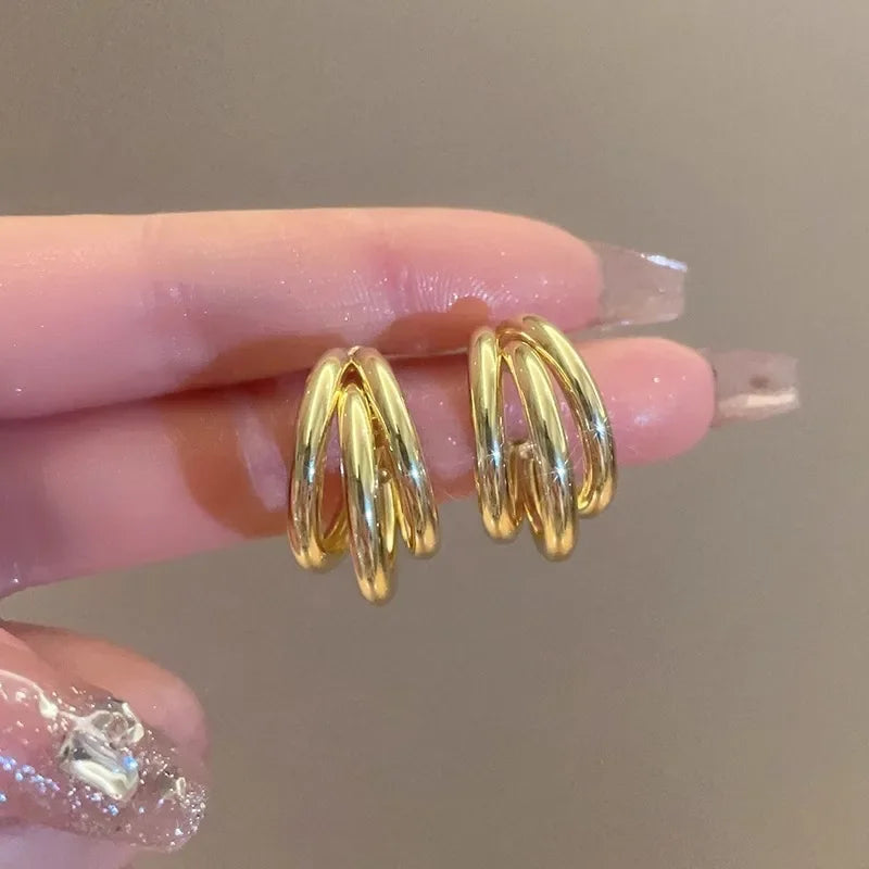 Elegant gold-tone geometric hoop earrings. A bold vintage statement for parties and special occasions