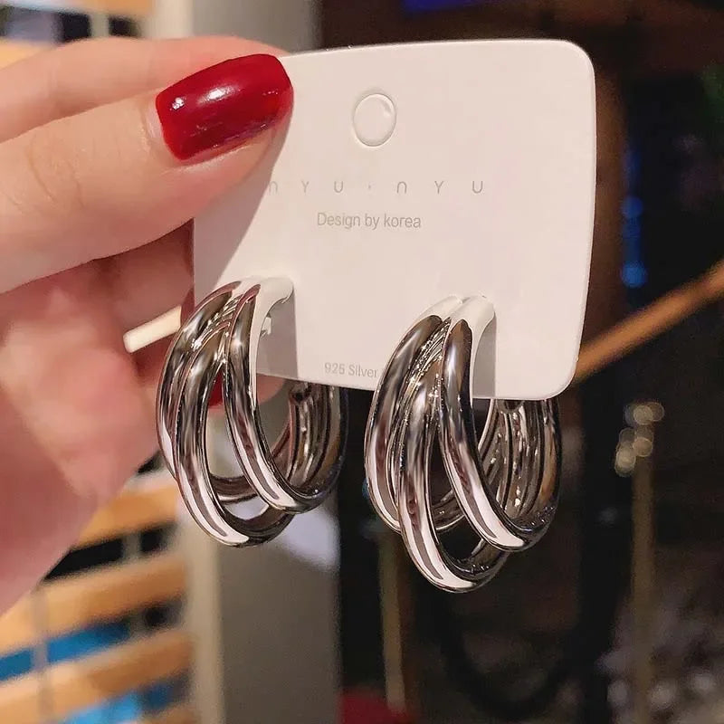 Elegant gold-tone geometric hoop earrings. A bold vintage statement for parties and special occasions