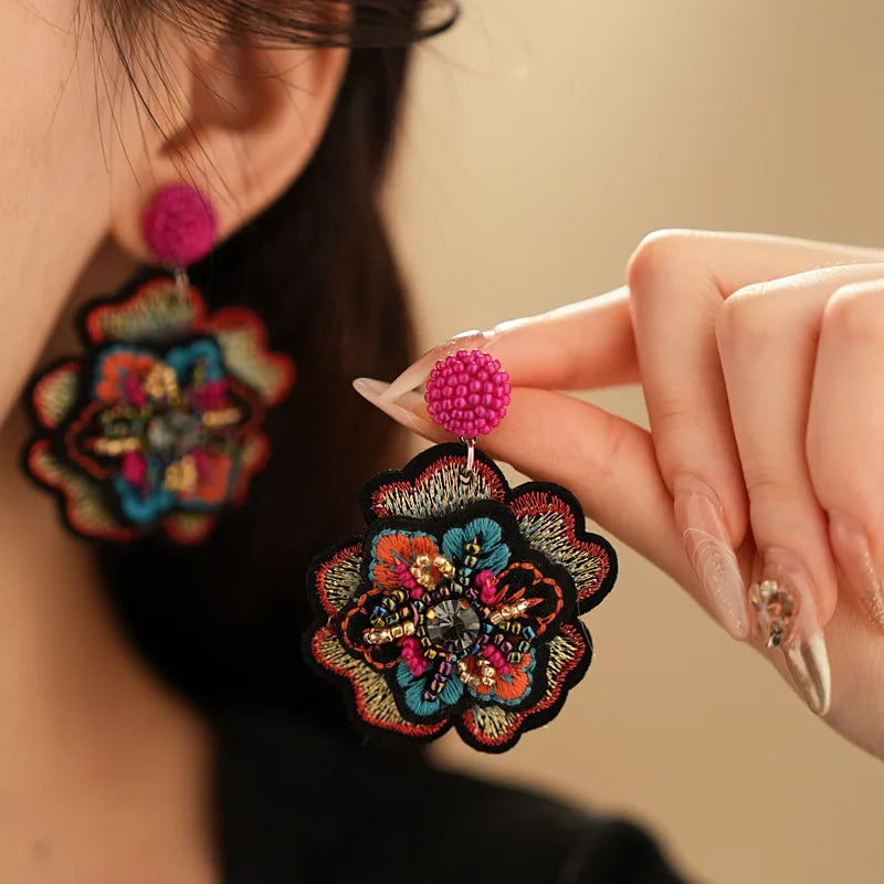 Embroidered flower drop earrings with colorful rice beads. Unique and elegant.