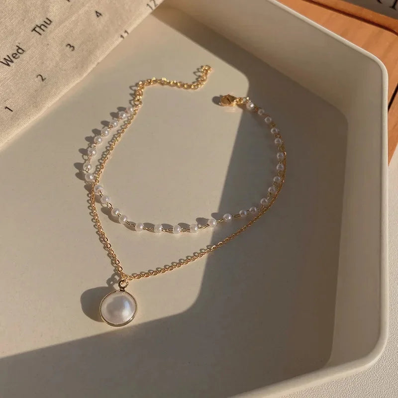 Hollow Heart Charm Bracelet for Women – Pearl & Fireball Accents.
