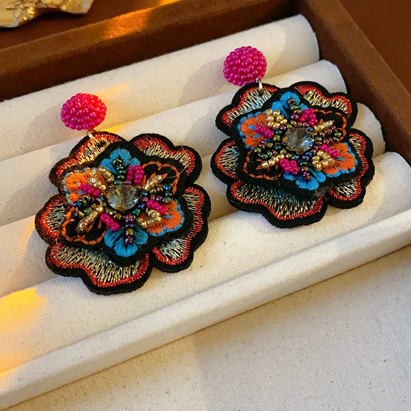 Embroidered flower drop earrings with colorful rice beads. Unique and elegant.