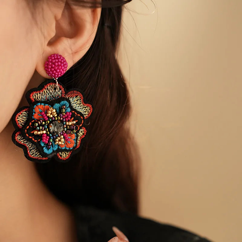 Embroidered flower drop earrings with colorful rice beads. Unique and elegant.
