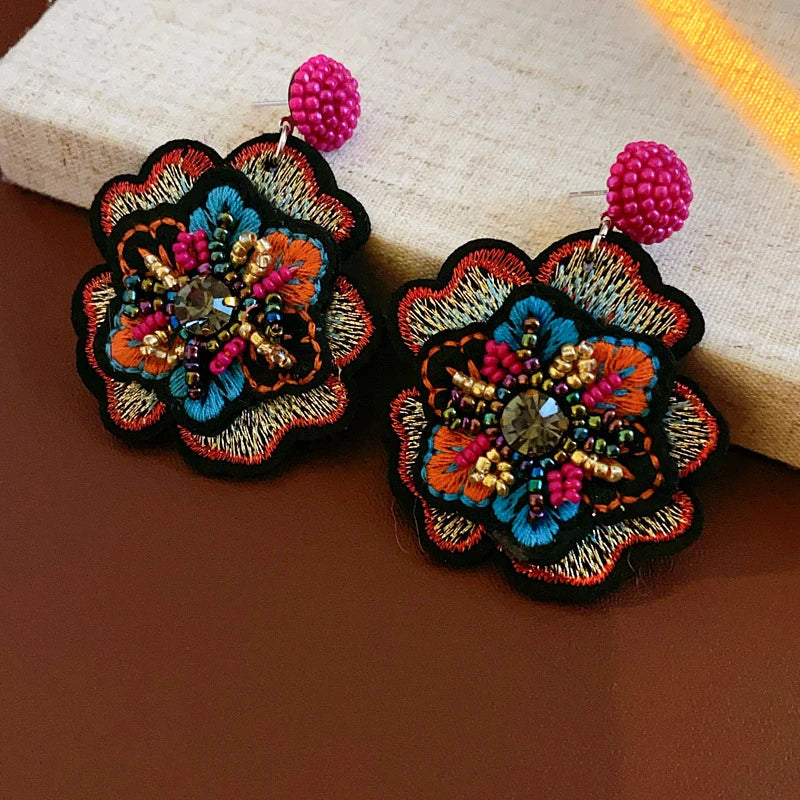 Embroidered flower drop earrings with colorful rice beads. Unique and elegant.