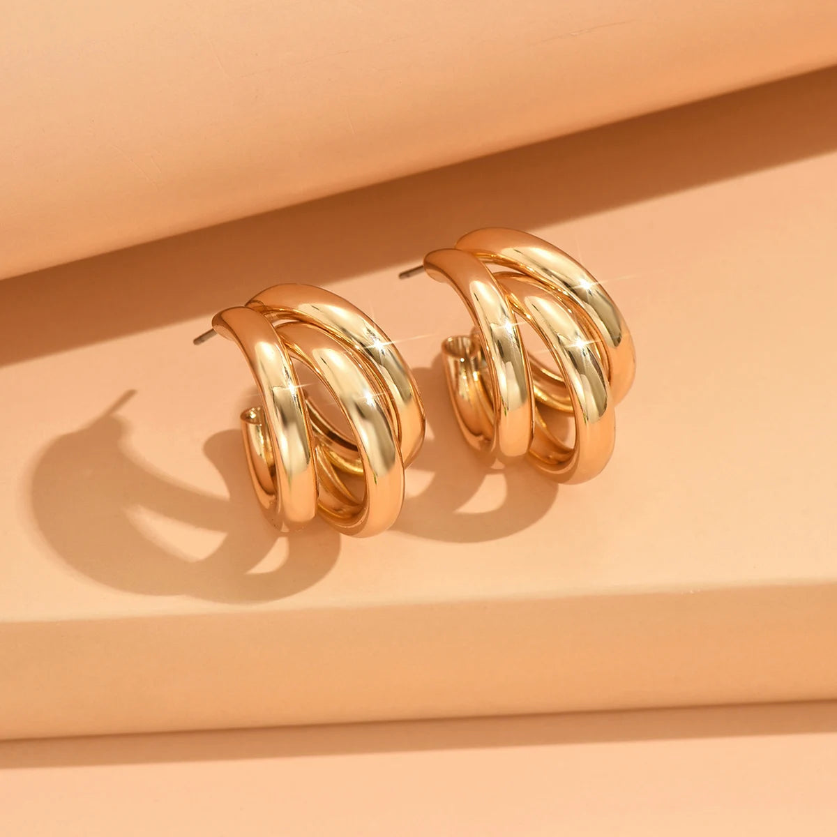 Elegant gold-tone geometric hoop earrings. A bold vintage statement for parties and special occasions
