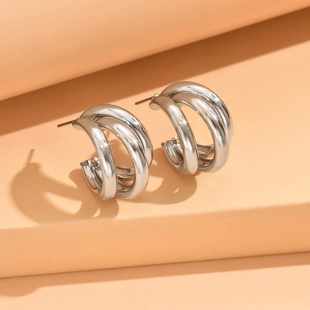 Elegant gold-tone geometric hoop earrings. A bold vintage statement for parties and special occasions