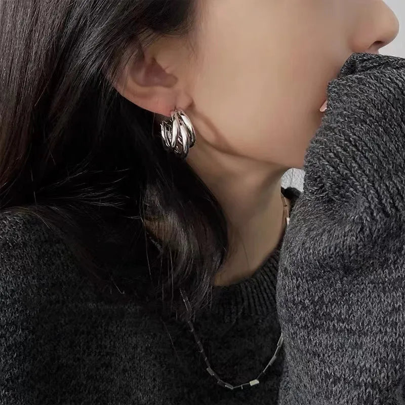 Elegant gold-tone geometric hoop earrings. A bold vintage statement for parties and special occasions