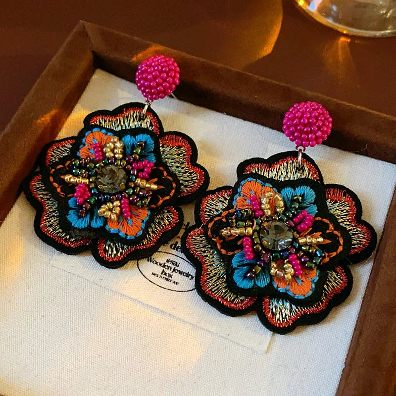 Embroidered flower drop earrings with colorful rice beads. Unique and elegant.