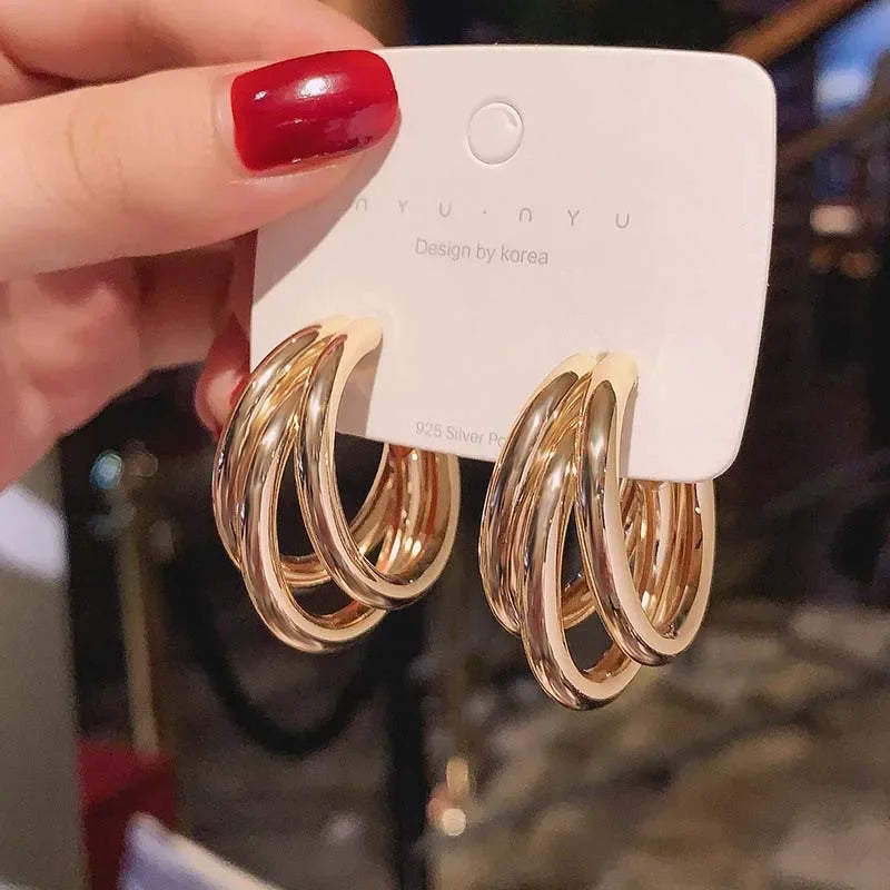 Elegant gold-tone geometric hoop earrings. A bold vintage statement for parties and special occasions