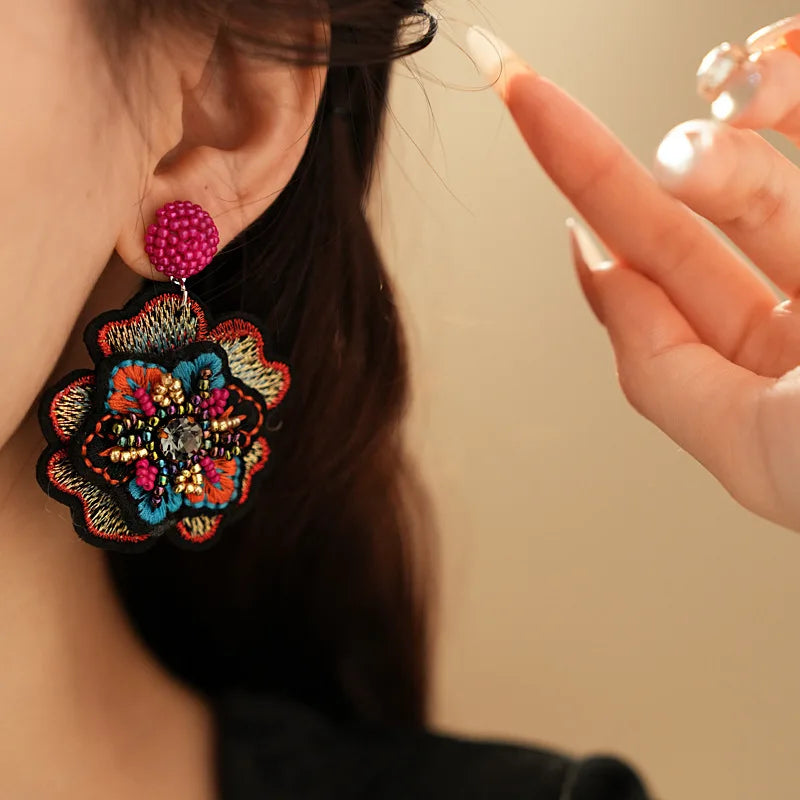 Embroidered flower drop earrings with colorful rice beads. Unique and elegant.
